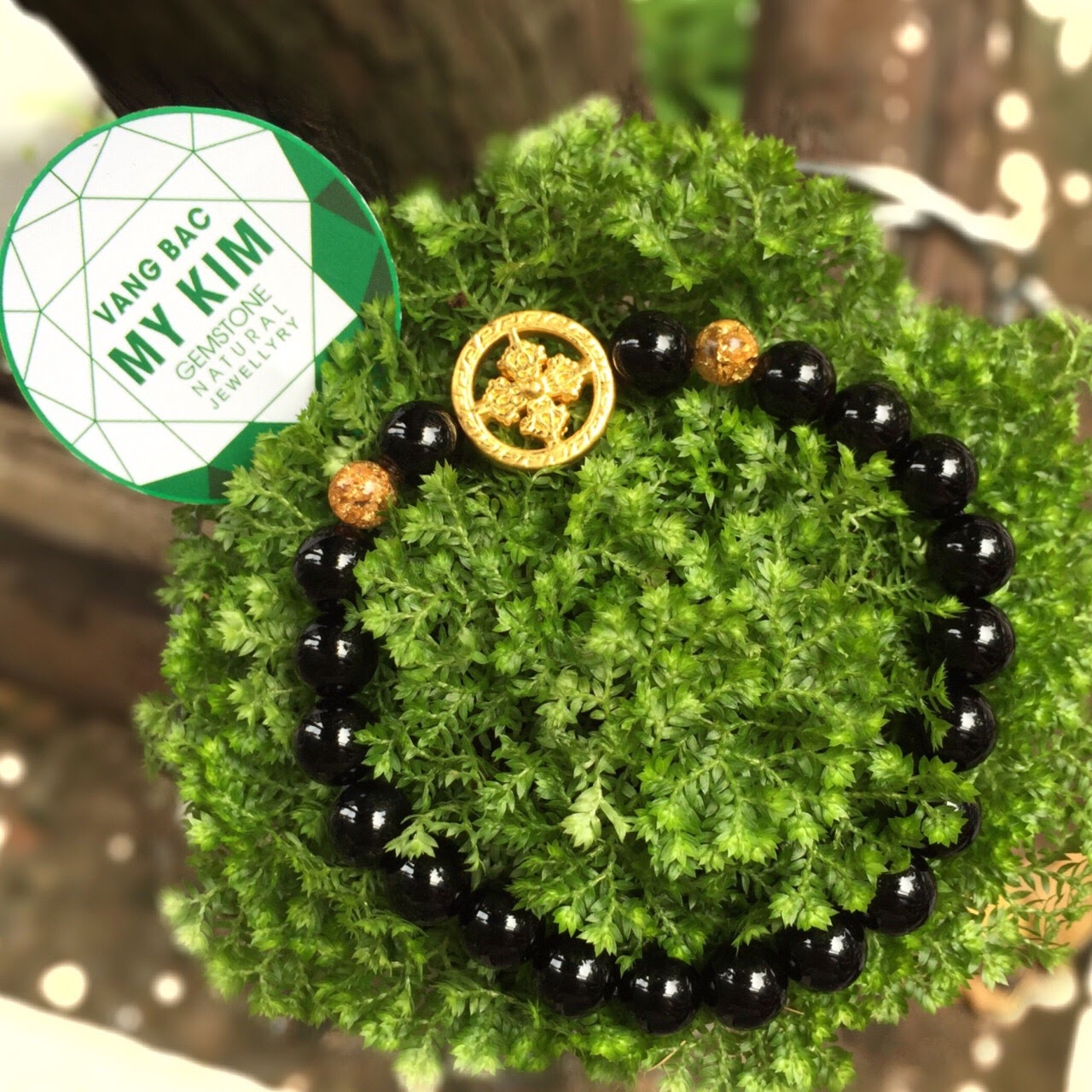 Vòng đá tektit mix charm bánh xe Pháp luân si vàng 24k